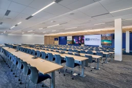 A 240-seat lecture hall with a massive 48-foot LED screen for immersive learning.