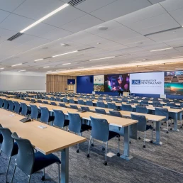 A 240-seat lecture hall with a massive 48-foot LED screen for immersive learning.