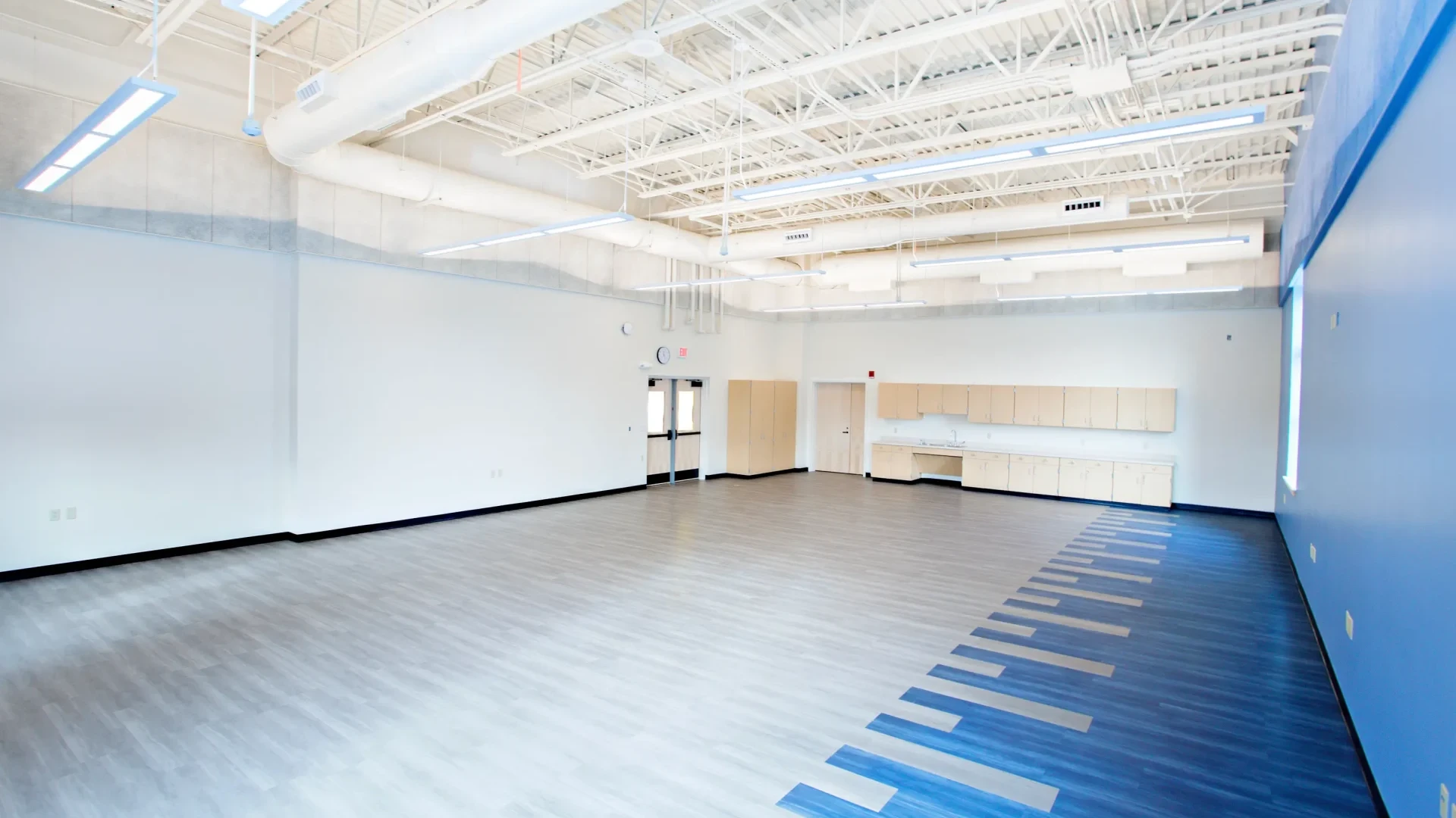 A view of the empty band room at Yarmouth High School. Large open space with lots of natural lighting.