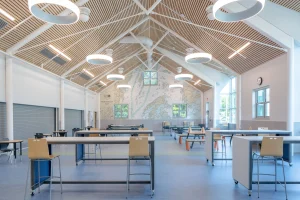 The high ceilings with wood accents and bright modern lighting adds to the bright aesthetic.