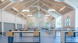 The high ceilings with wood accents and bright modern lighting adds to the bright aesthetic.