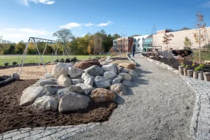 A photograph of the swing set and grassy field at the Camden-Rockport Middle School