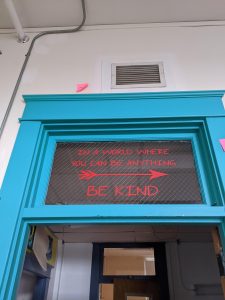 An image of the note above the door to the Mary E. Taylor building in Camden that says "In a world where you can be anything, be kind"